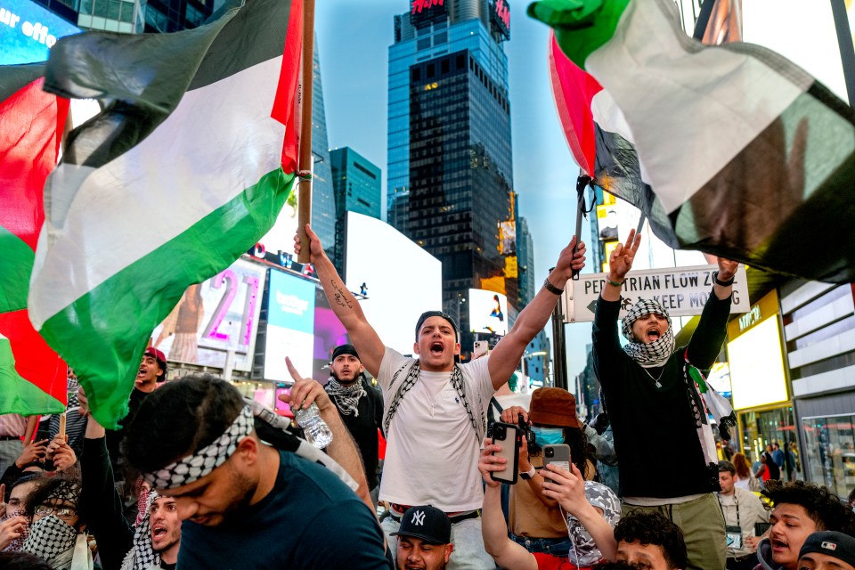 Flags are waved in the street by thrilled people after 11 days of fierce battle