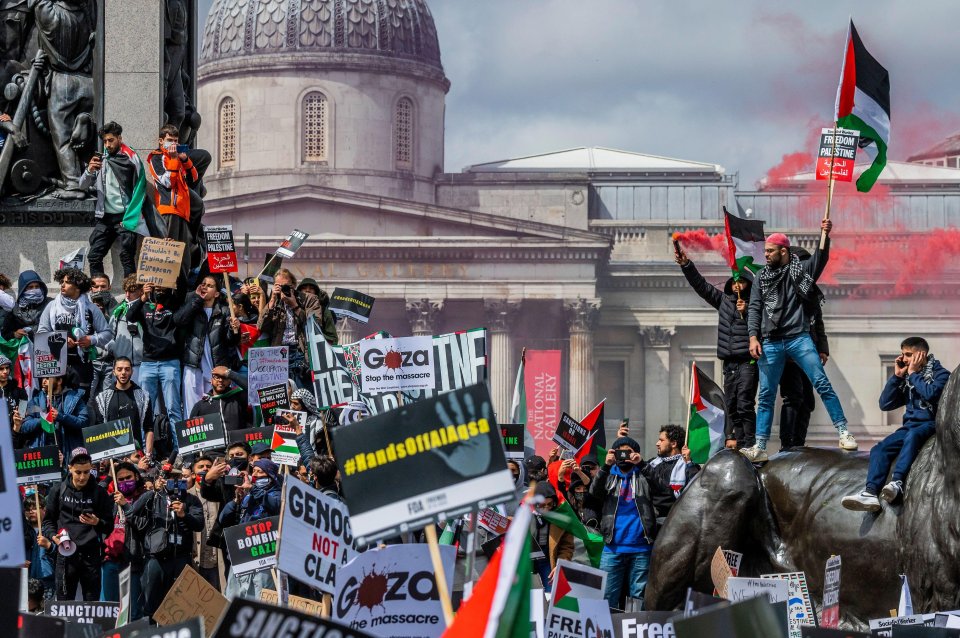 Protesters stood on the lions at Trafalgar Square