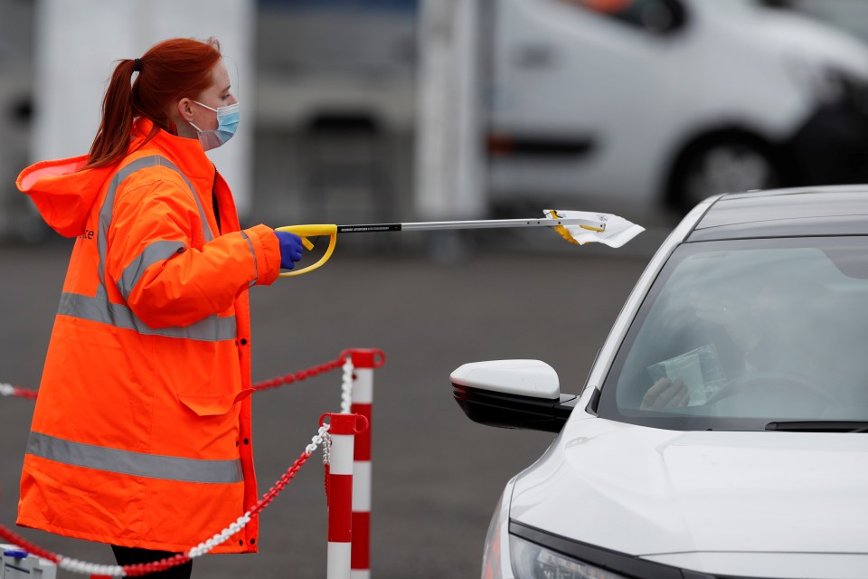 A Staff member collects a tests for coronavirus diseas in Bedford, May 25, 2021