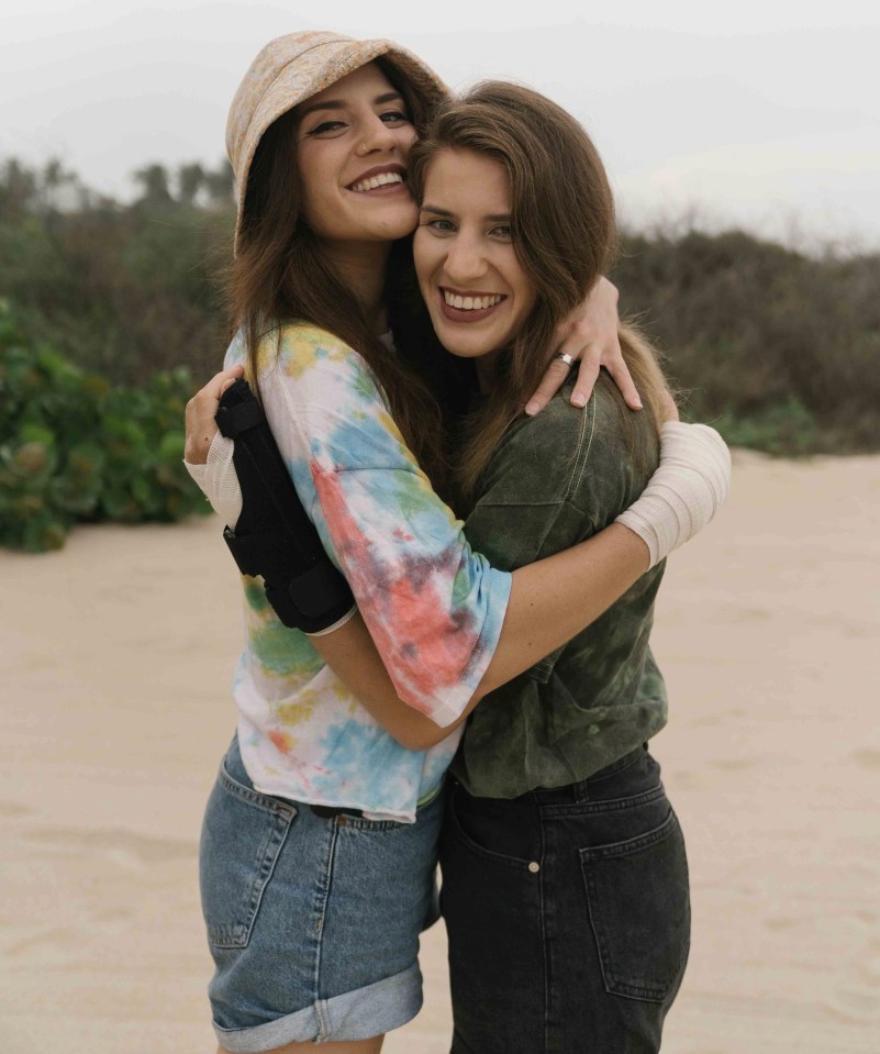 Crocodile attack victim Melissa Laurie wearing green t-shirt and twin sister Georgia who saved her life