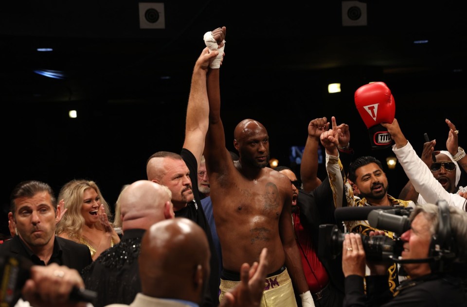 Ex-NBA star Lamar Odom celebrates his win with UFC legend Chuck Liddell