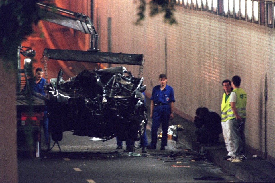 The wrecked Mercedes is removed from the crash scene