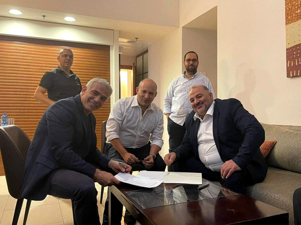 From left, Yair Lapid, Naftali Bennett and Mansour Abbas sign their coalition deal 