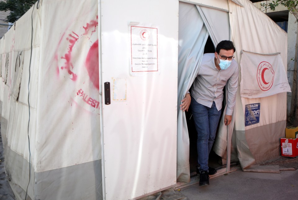 A man coming out a vaccination tent