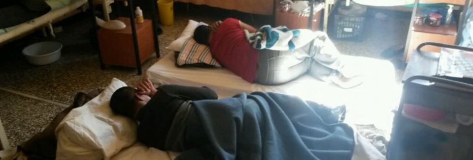 Prisoners lying on the ground in a hospital
