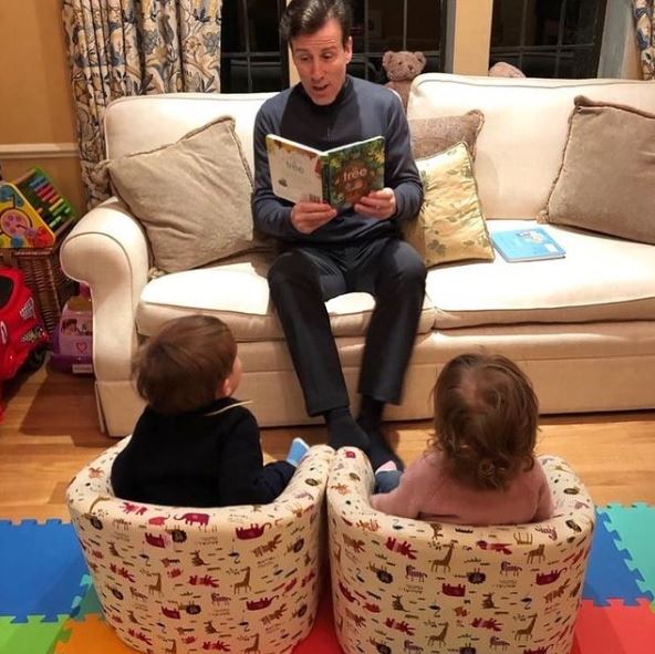 The children play in the lounge and listen to daddy reading stories