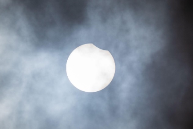 The moon begins its transit across the sun to produce a partial eclipse of the sun today across the UK CREDIT: Alamy