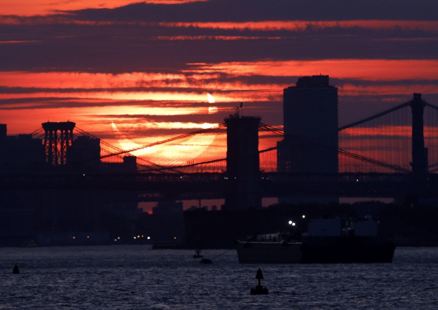 A partial eclipse behind the Brooklyn bridge in New York