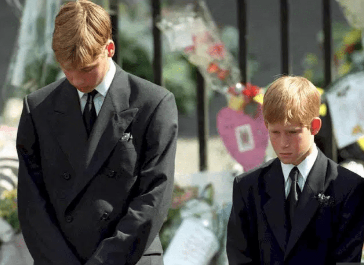 William and Harry bow their heads as their mother's coffin is taken out of Westminster Abbey