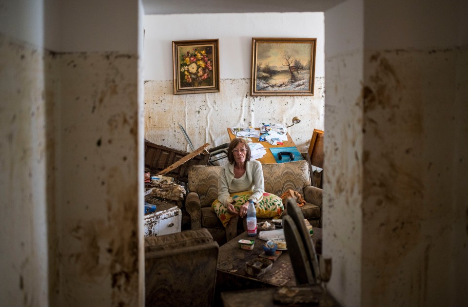 Jutta Schnelleckes, 72, sits in the living room of her apartment, which was completely destroyed by the flood on July 17 in Bad Neuenahr