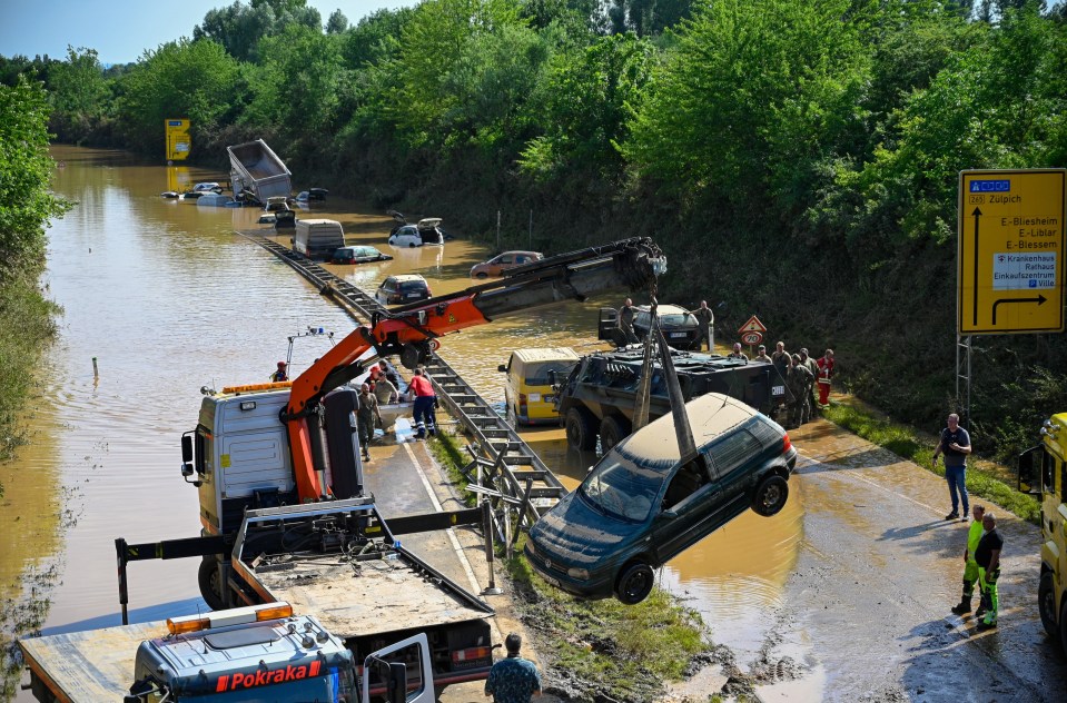 Search and rescue teams on a flooded and damaged part of the highway on July 17 in Erftstadt, Germany