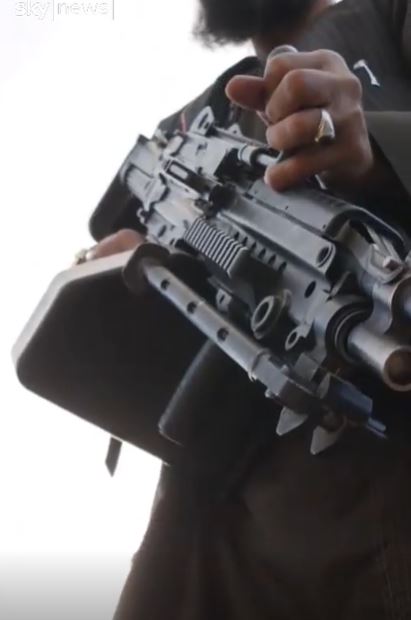 A Taliban member shows off new weapons abandoned by the US as Afghan officials ‘flee’