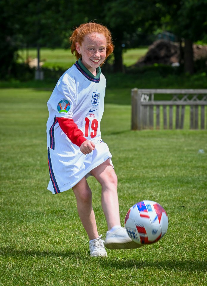Belle tries out her prized shirt given to her by Mason Mount at Wembley