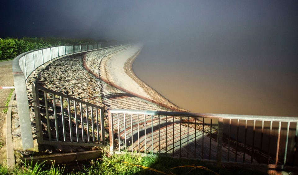 The dam wall of the Steinbach reservoir is seen in fog last night amid fears it could collapse