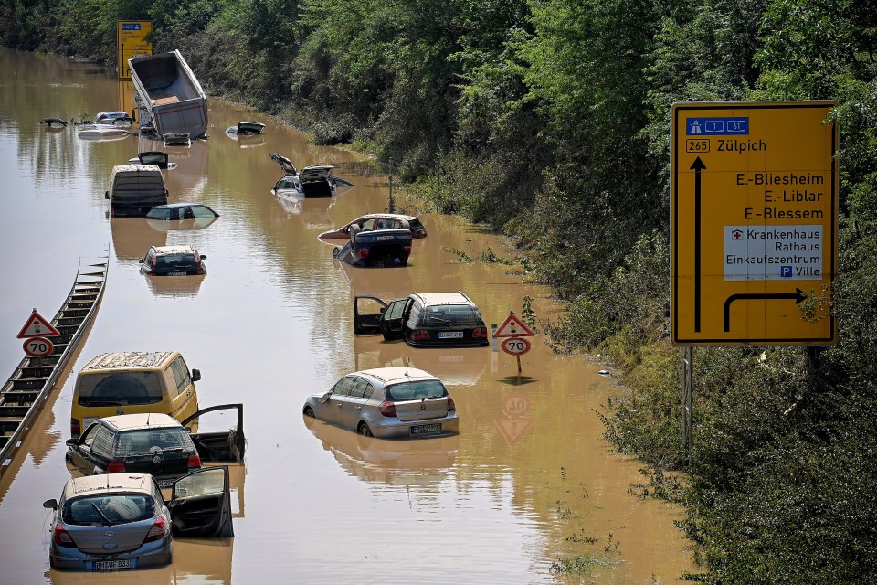Wrecked cars and trucks are flooded on the B265 federal highway in Erftstadt