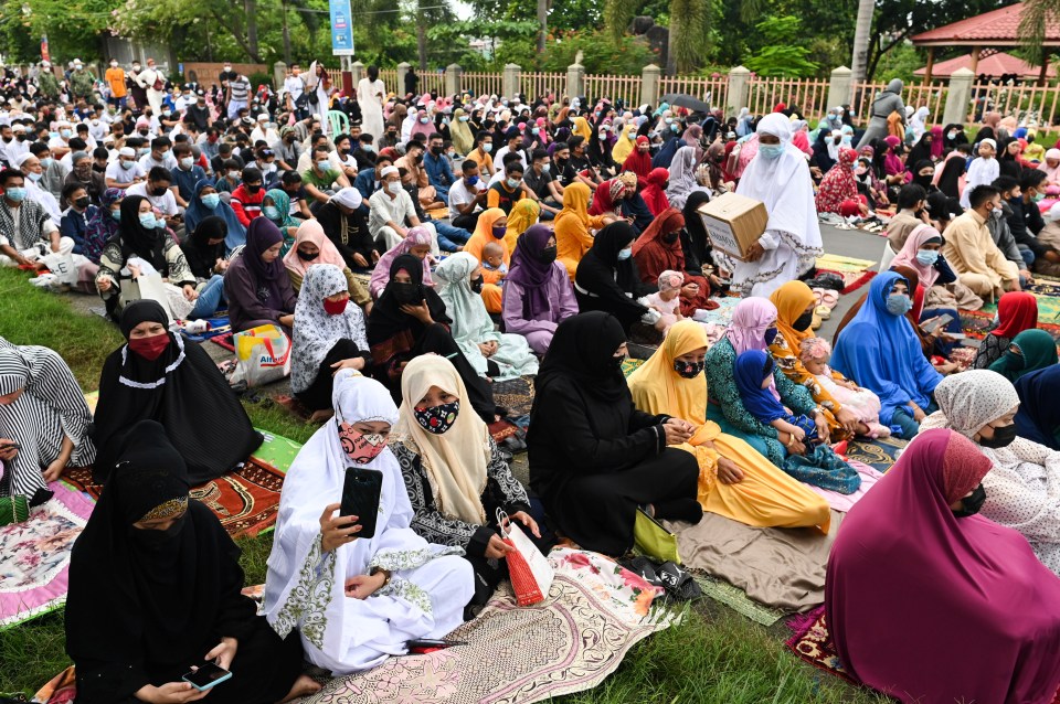 Filipino Muslims wearing masks gather for the morning prayers on Eid al-Adha