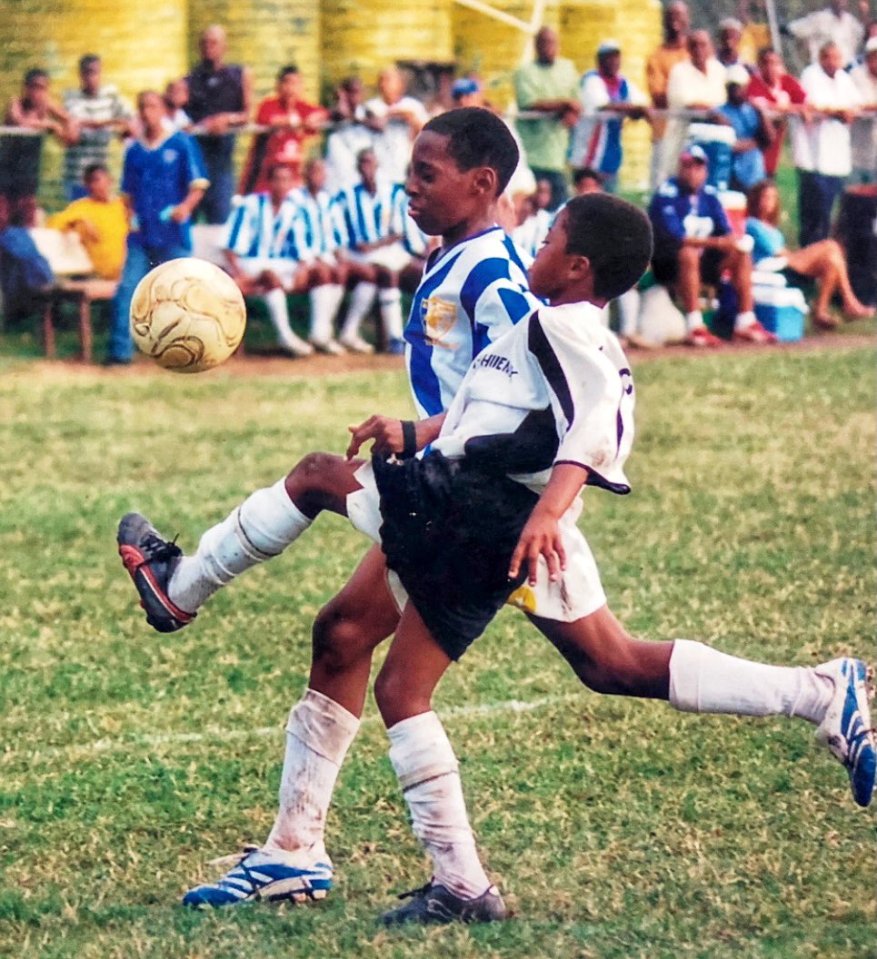 Winger Bailey wearing black and white seen showcasing his skills in Jamaica aged 10