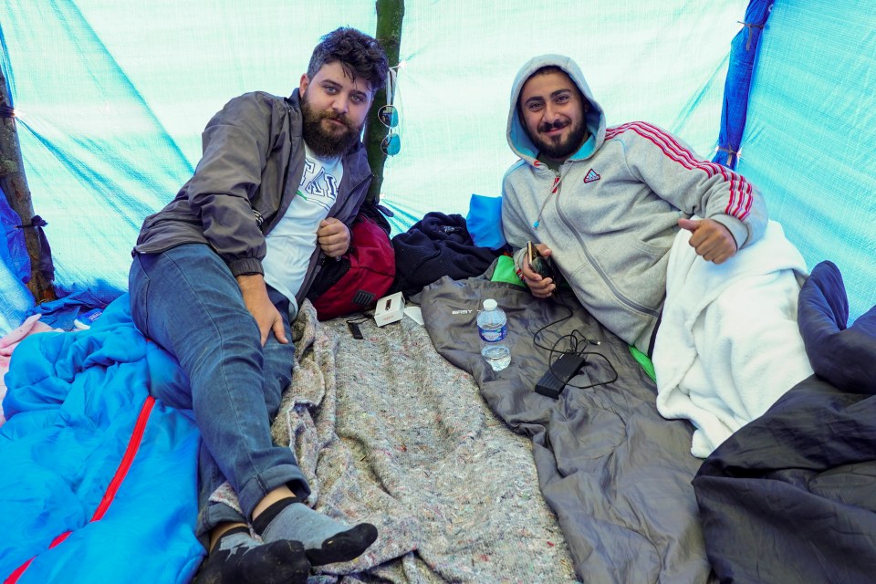 Vaping in their tarpaulin lean-to, friends Mira Ibrahimy, 26, and Aryas Shabany, 28, make the universal cut-throat sign when I ask what would happen if they returned to Iran