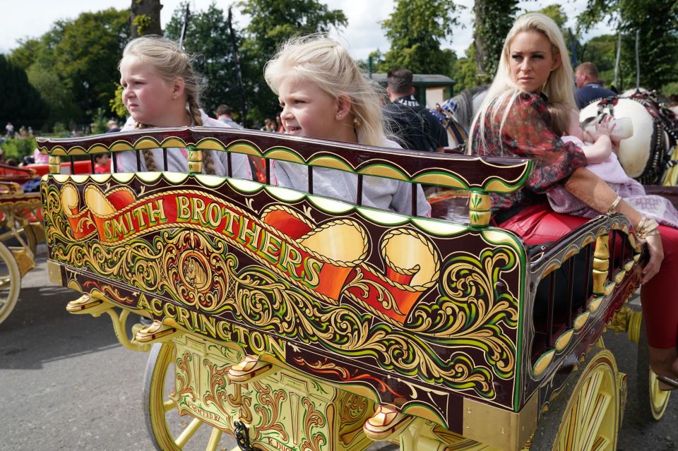 Children and their mother sit in a horse drawn carriage in Appleby