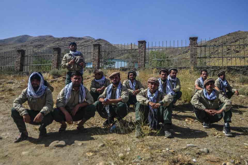 Afghan youths who will be inducted in Afghan Security forces who are resisting the Taliban sit along a road in Panjshir province of Afghanistan