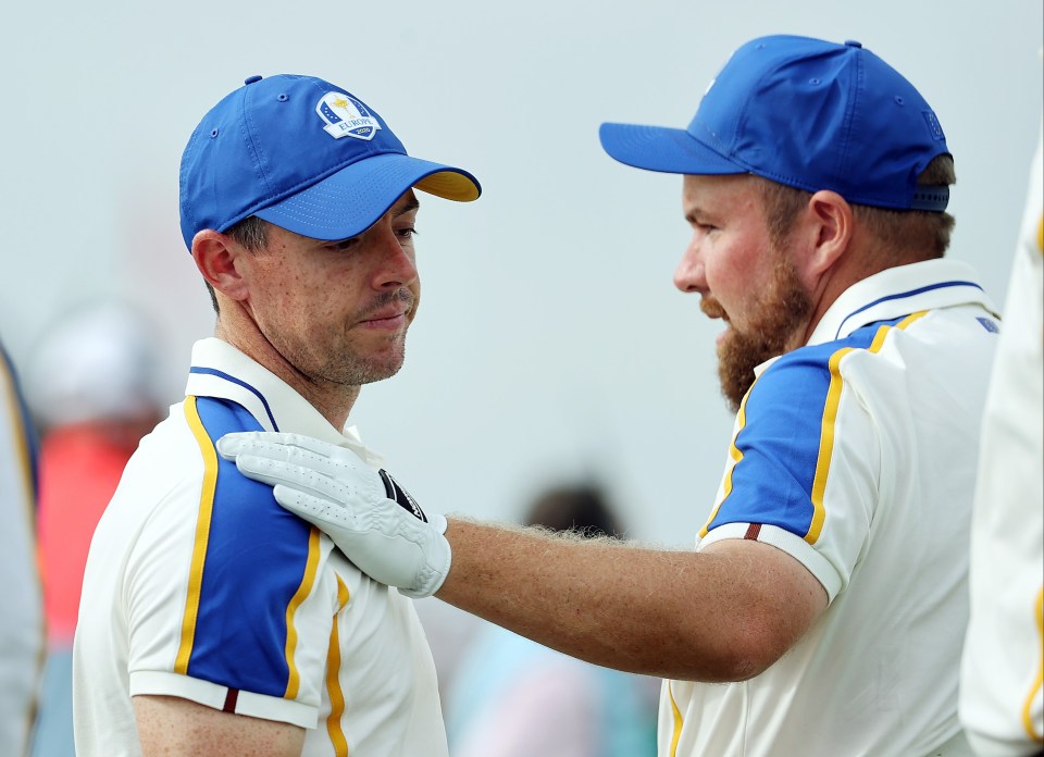 Shane Lowry comforts a visibly upset McIlroy