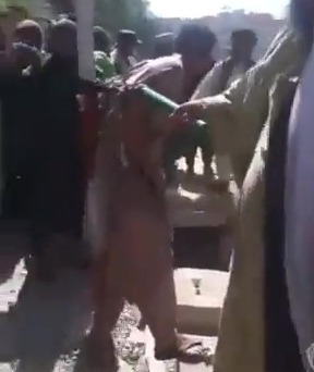 The man writhing in agony as he is flogged