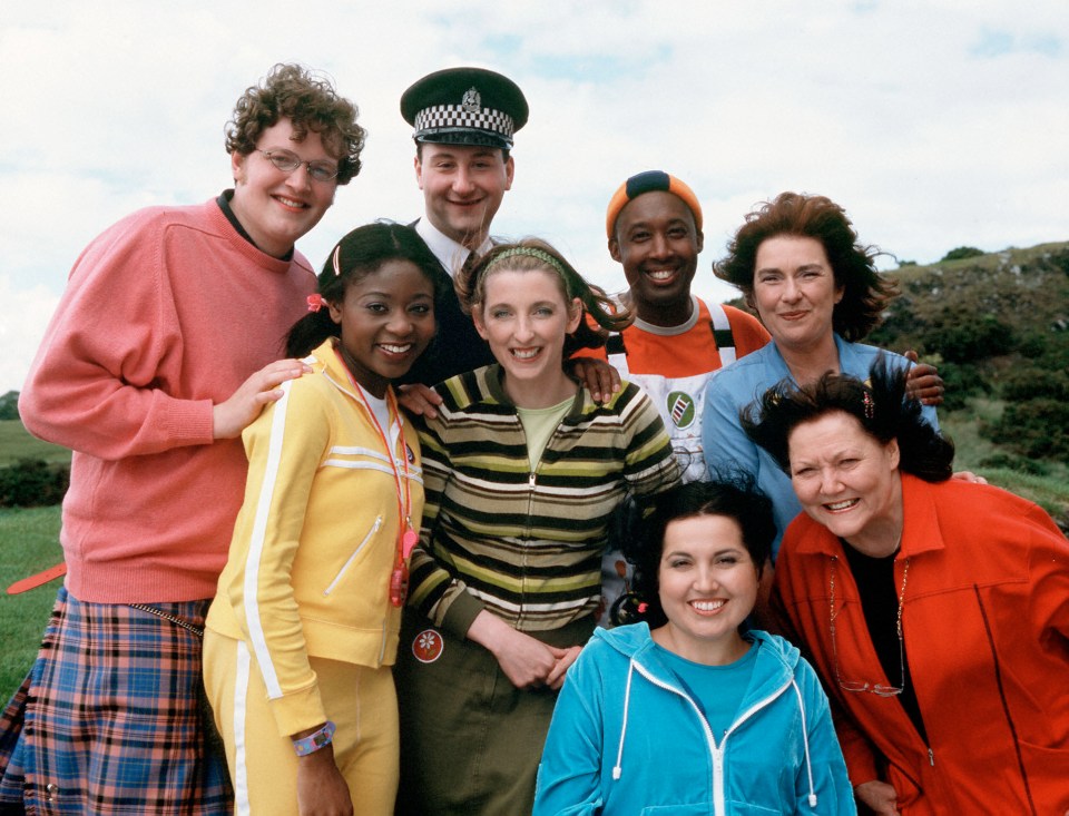 a group of people posing for a picture with one wearing a badge that says ' sdf ' on it