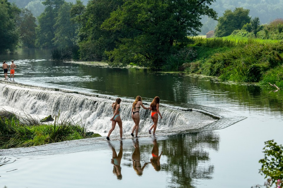 Pals enjoy the water at Warleigh Weir on the River Avon near Bath in Somerset