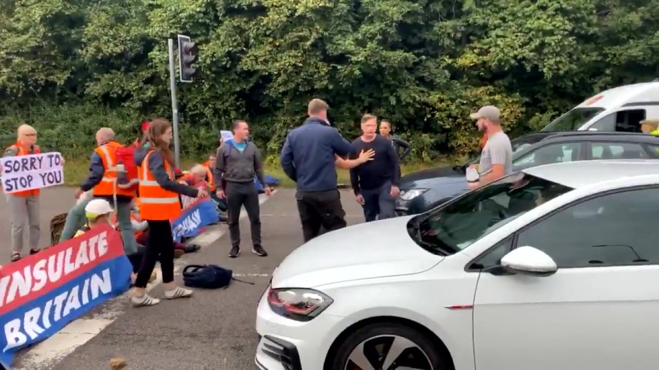 Angry motorists tried to haul the eco warriors off the road as the protest turned violent
