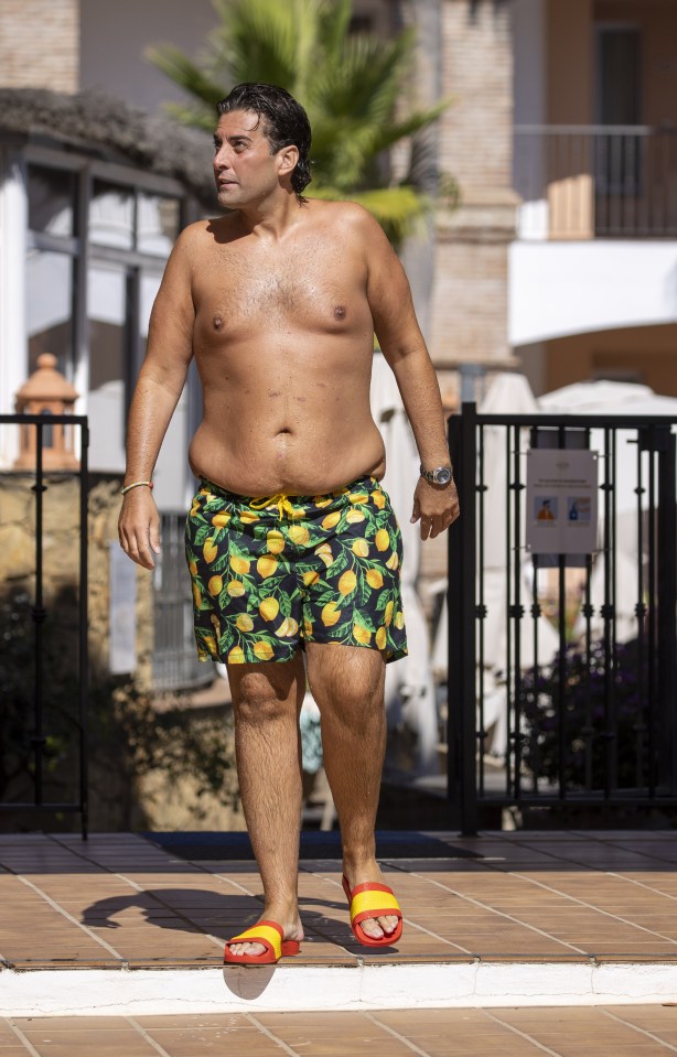 The star showed off his shrinking frame in some funky swimming shorts
