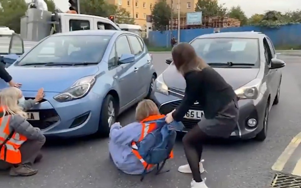 One commuter took action herself and pulled the protesters off the road at the industrial estate