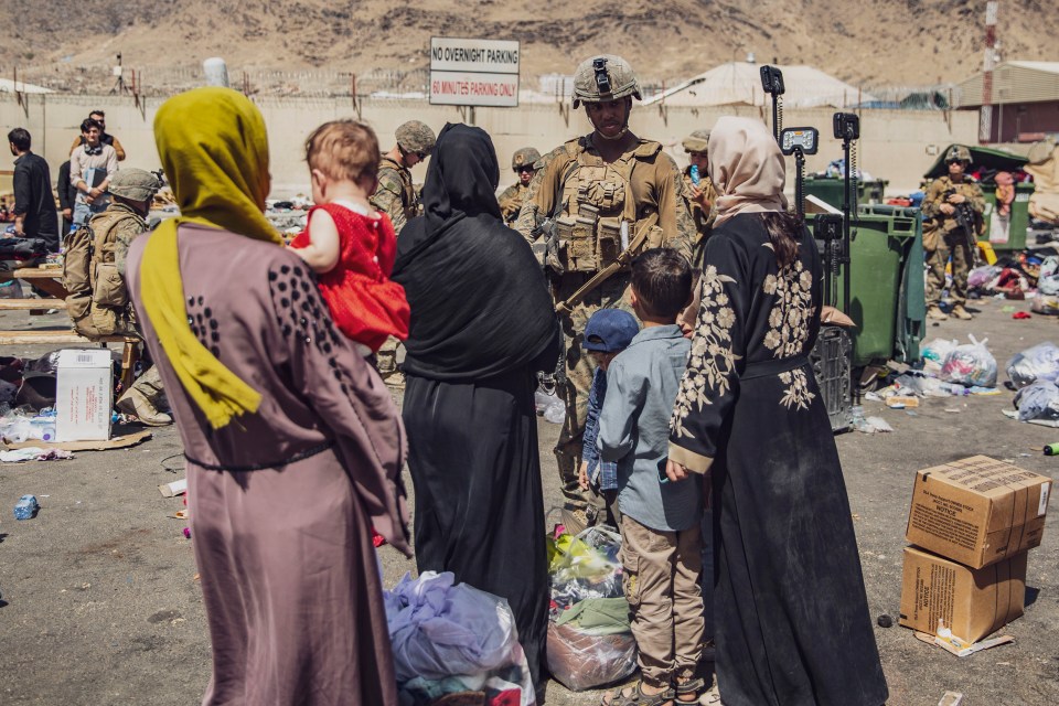 Afghan people waiting to flee Kabul in August 2021