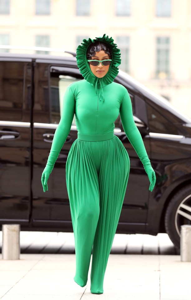 Cardi B later explored the French capital in a quirky green all-in-one ­complete with frilly bonnet