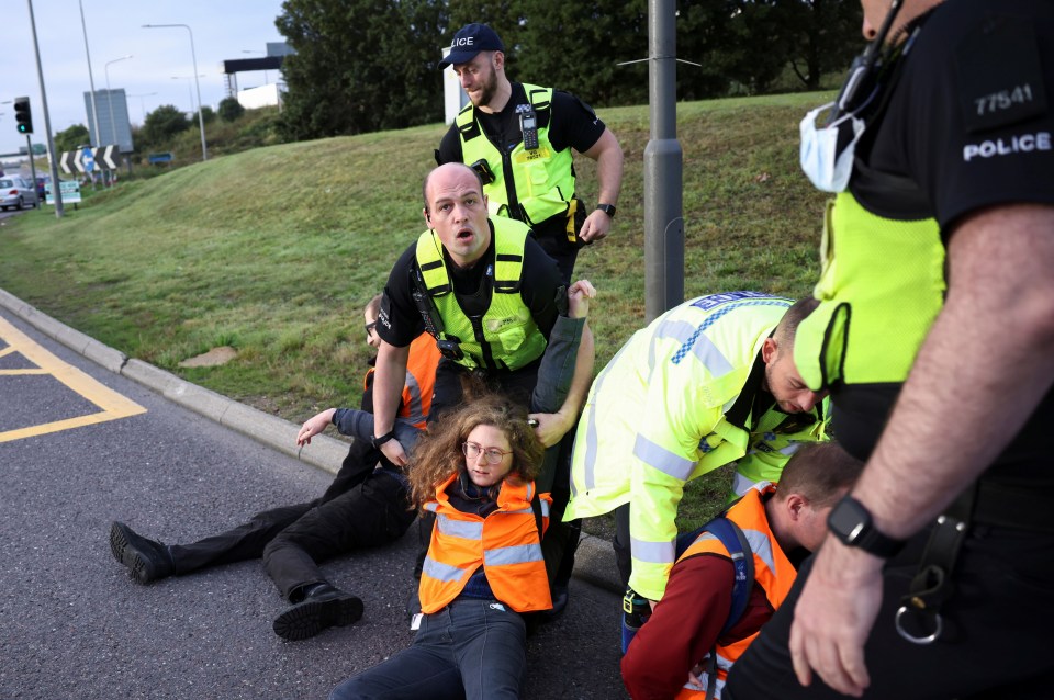 Police were seen removing demonstrators from the road themselves