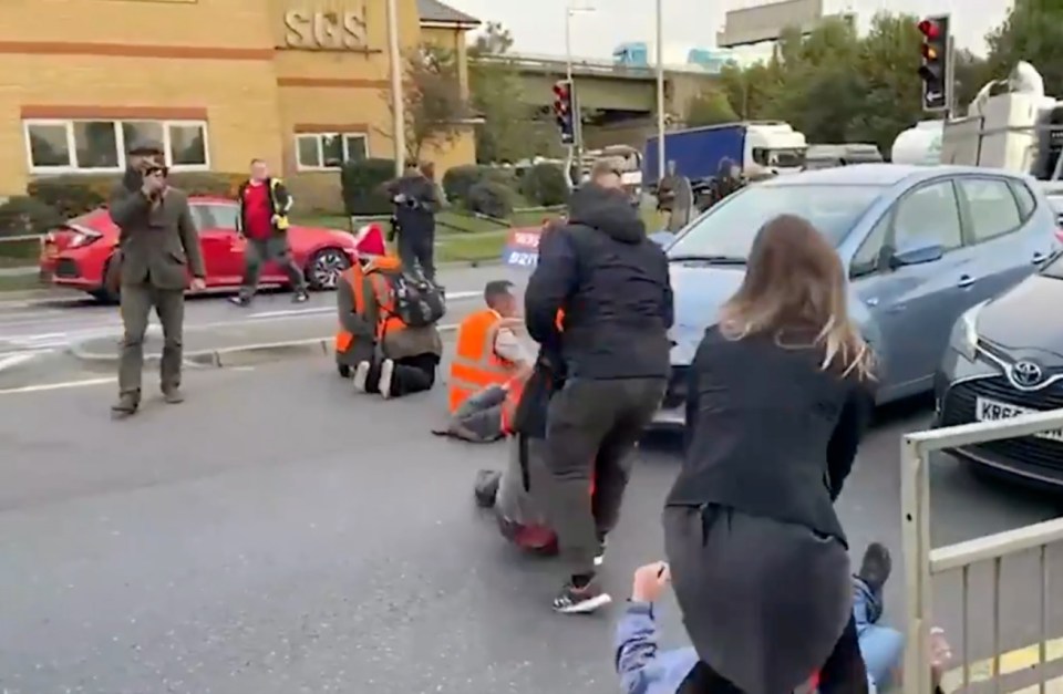 Two frantic demonstrators dragged protesters off the road themselves