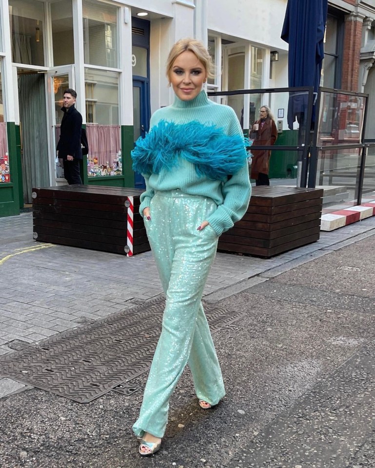 Kylie was pictured out in London in a blue jumper with furry front