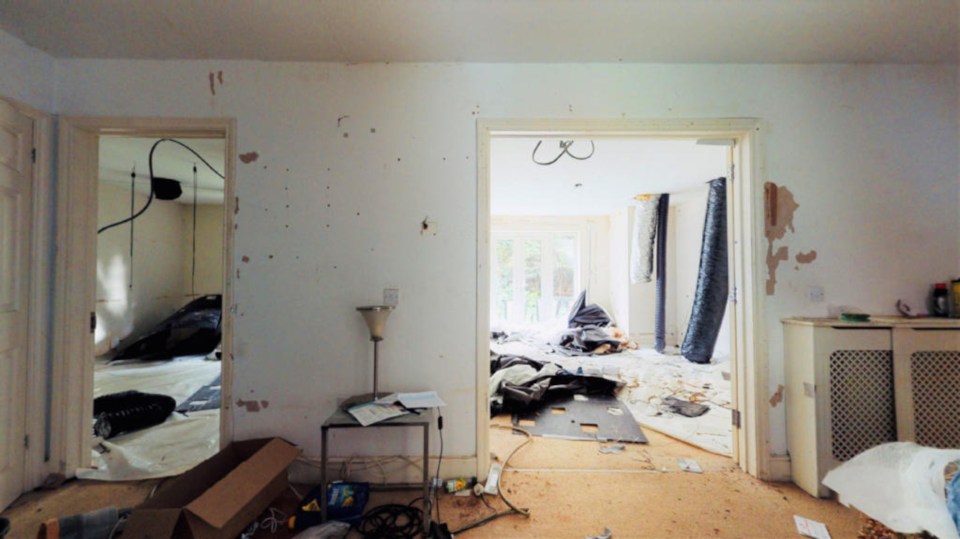 Black ventilation pipes can be seen dangling from the ceiling in one of the bedrooms