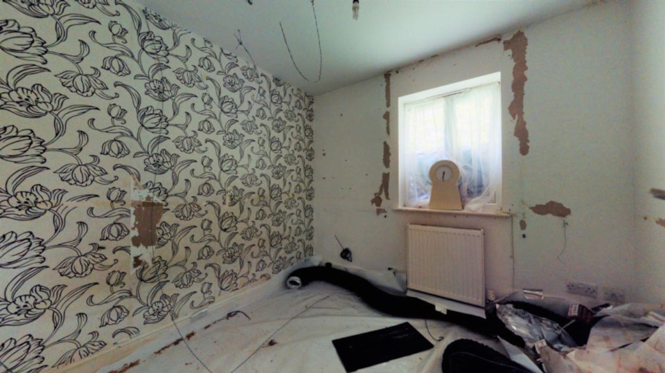 One of the bedroom walls has been stripped down to the plaster