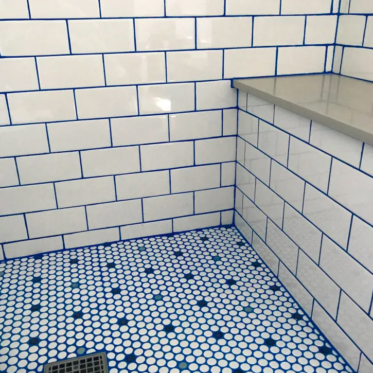 Use grout pens to paint over the lines between tiles to spruce up the bathroom