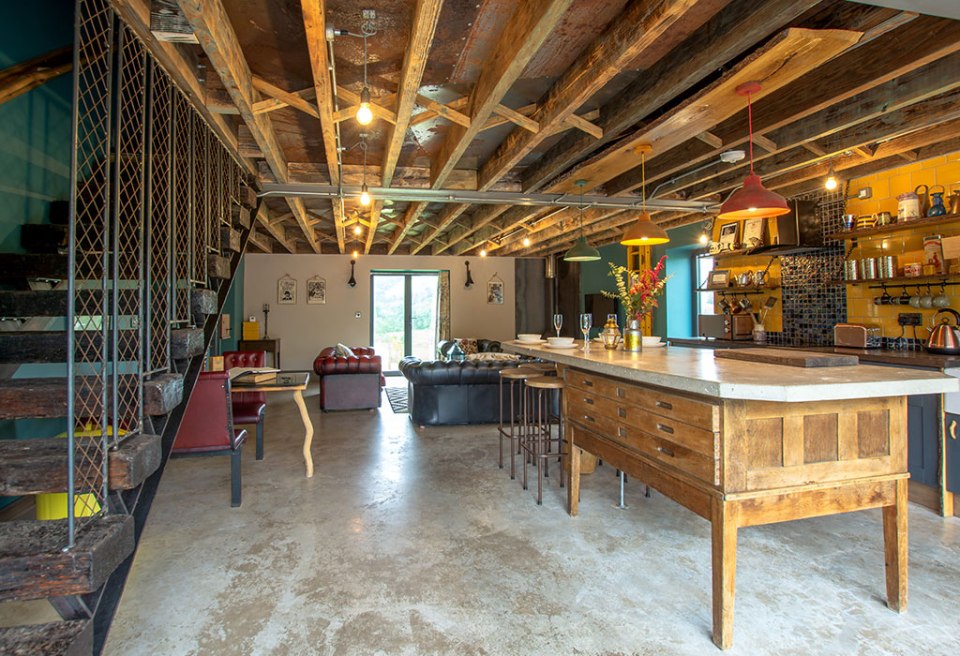 It features an open plan living area, six-person hot tub and barbecue