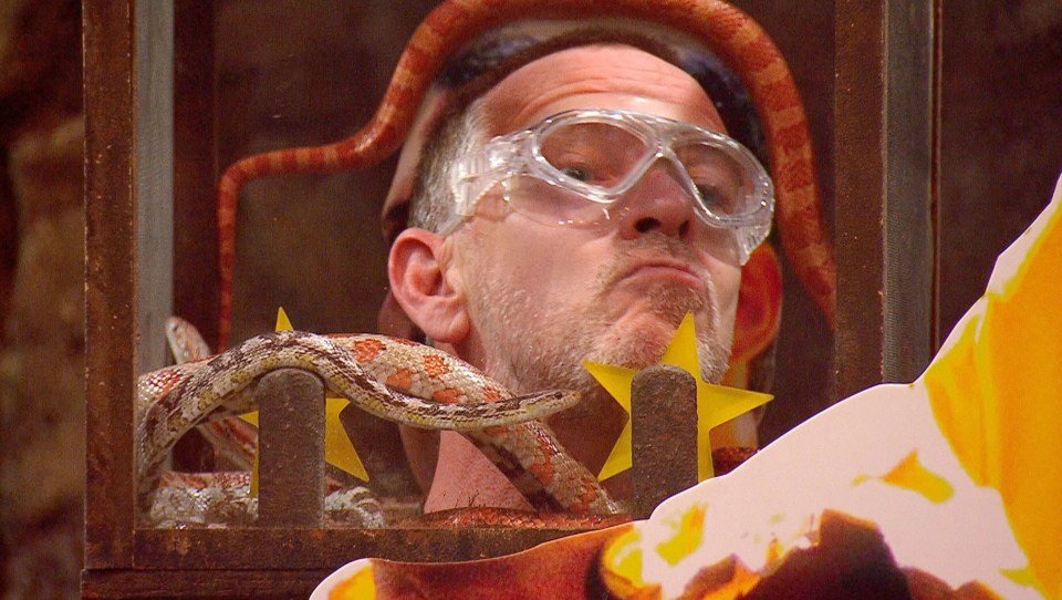 Adam Woodyatt cranes his neck to get away from a snake