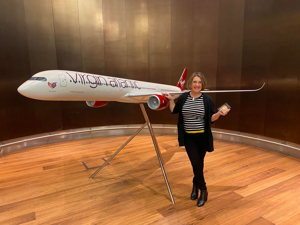 The Sun's Lisa Minot poses next to a Virgin Atlantic plane at Heathrow as she prepares to board her flight to New York this morning