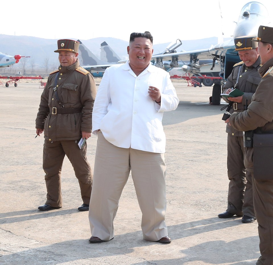 A more portly Kim Jong-un has a smoke while visiting a military base last year