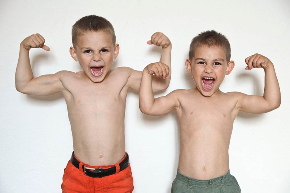 Brothers Giuliano (right) and Claudiu Stroe flexing their muscles in front of the camera