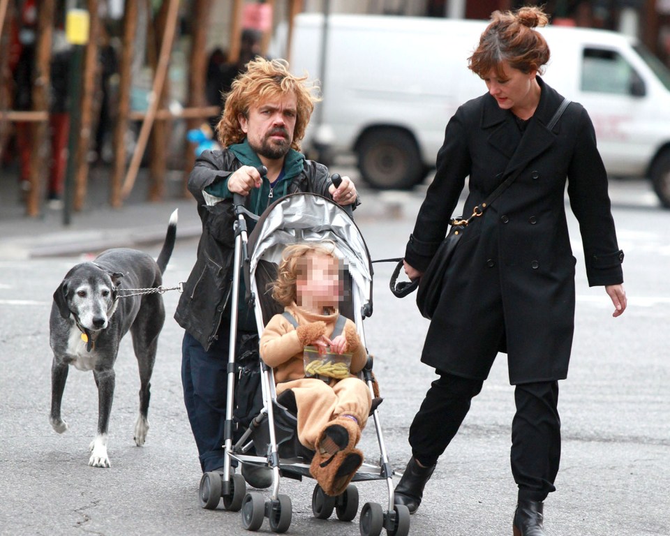 Peter and Erica out and about with their child and family dog