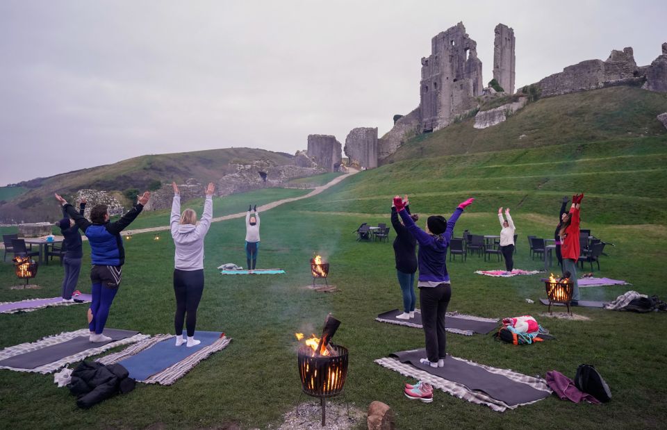 Brits took part in a winter solstice yoga session at the National Trust's Corfe Castle in Dorset this morning