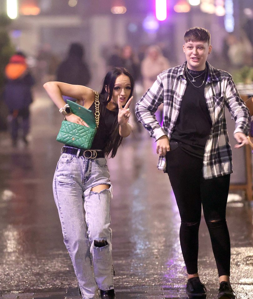 A Christmas reveller throws up the peace sign in Leeds
