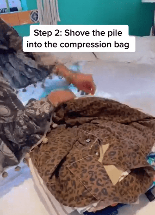 She laid her clothes flat and shoved them into a compression bag