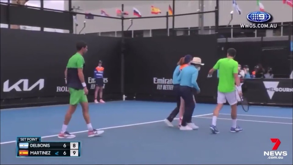 The two players, two officials and the chair umpire came to the youngster's aid