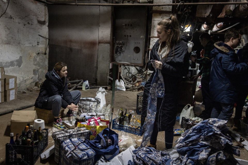 Volunteers making Molotov cocktails in the basement of a bomb shelter earlier today